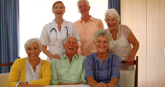 Happy Seniors Group Celebrating with Caregiver in Comforting Environment - Download Free Stock Images Pikwizard.com