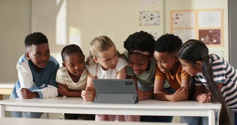 Multiracial Elementary Students Gathering Around Tablet for Collaborative Learning