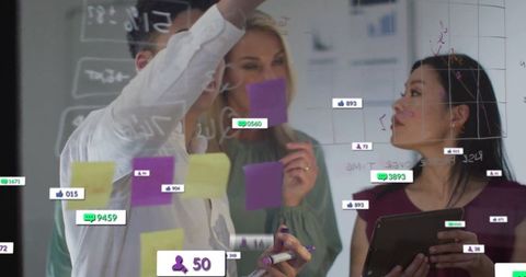 Team Collaborating on Glass Board with Digital Metrics Overlays