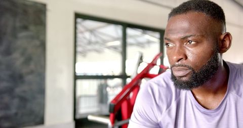 Focused athlete resting during intense workout in gym