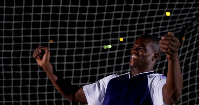 Joyful Soccer Player Celebrating Victory Under Stadium Lights at Night - Download Free Stock Images Pikwizard.com