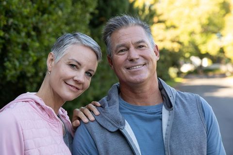 Joyful Senior Couple Enjoying Leisure Walk in Sunny Suburban Area