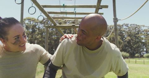 Diverse Soldiers Resting on Army Obstacle Course Together