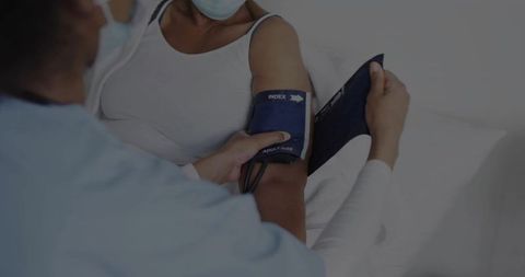 Nurse Checking Blood Pressure of Patient in Hospital Setting