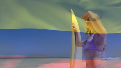 Surfing Enthusiast Holds Board Under Colombian Flag