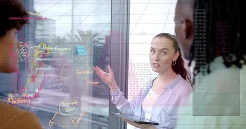 Businesswoman Presenting Strategy on Glass Board with Tablet Collaborating in Office