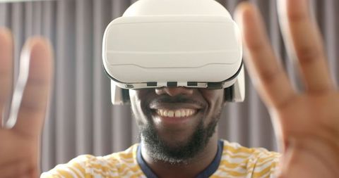 Man Smiling While Exploring Virtual Reality Wearing Headset