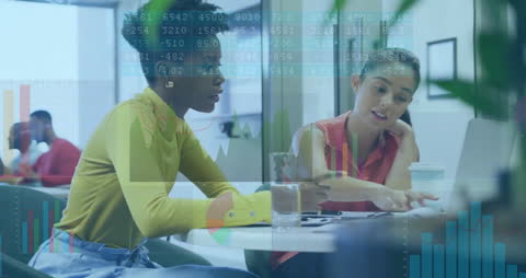 Diverse Team Analyzing Financial Data on a Laptop in Modern Office