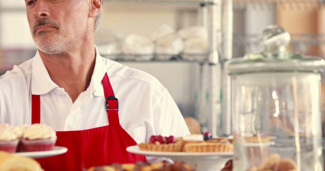 Senior Baker Displaying Fresh Pastries in Bakery Shop - Download Free Stock Images Pikwizard.com