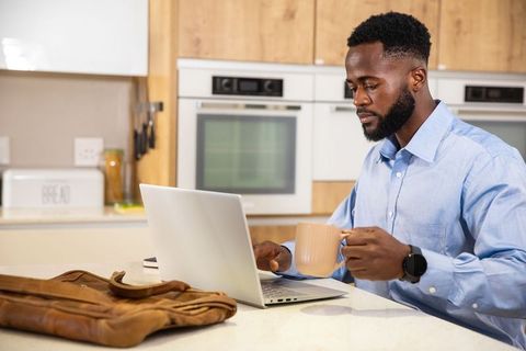 Professional Working from Home with Coffee at Kitchen Island