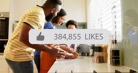 Family washing hands together in bright kitchen with social media likes overlay