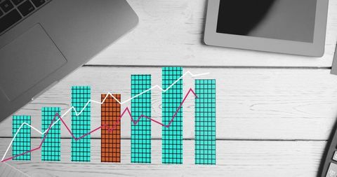 Presenting digital data visualization on white wooden desk with teal bar chart and trend lines