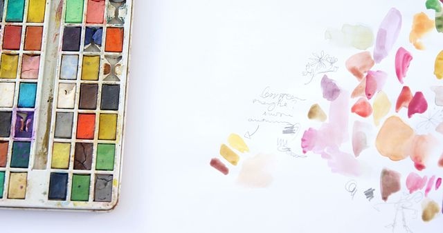 Watercolor paint with paintbrush and canvas on wooden background