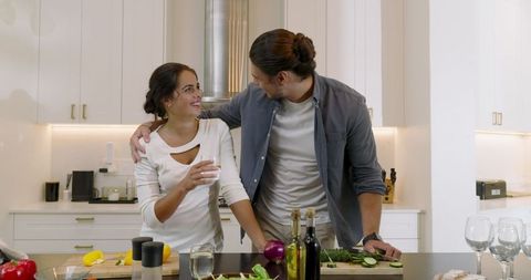 Happy Couple Preparing Healthy Meal Together in Modern Kitchen