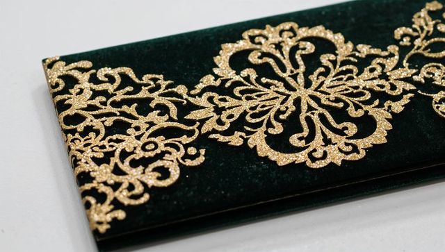 Emerald velvet envelope with gold glitter filigree ornamentation for luxury invitations