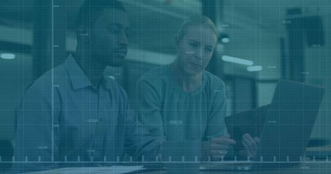 Corporate Professionals Analyzing Data on Laptop in Modern Office