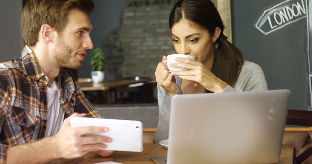 Young Adults Collaborating Over Coffee with Digital Devices - Download Free Stock Images Pikwizard.com