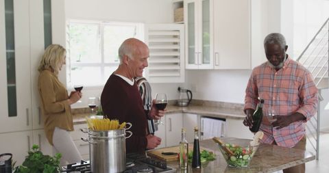 Senior Couples Socializing in Kitchen While Cooking Dinner