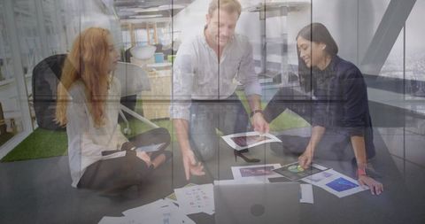 Creative team reviewing printed mockups during collaborative design brainstorming session