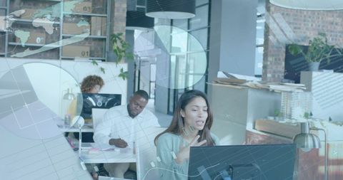 Multi-ethnic team analyzing data in modern office environment