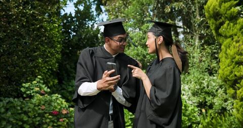 Graduating Students Celebrating with Selfie in Garden