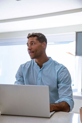 Professional Male Using Laptop at Modern Office Desk