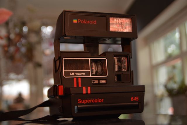 Vintage Polaroid Supercolor 645 Camera Close-Up on Table - Download Free Stock Photos Pikwizard.com