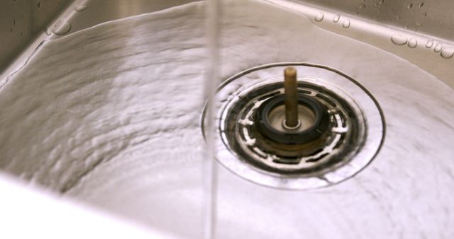 Close up of kitchen sink with flowing water