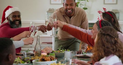Family Celebrating Holiday Meal with Toast and Festive Cheer