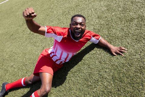 Soccer Player Celebrating Goal with Passion and Energy on Turf