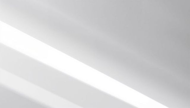 Diagonal light band creating minimalist monochrome gradient with soft parallel streaks