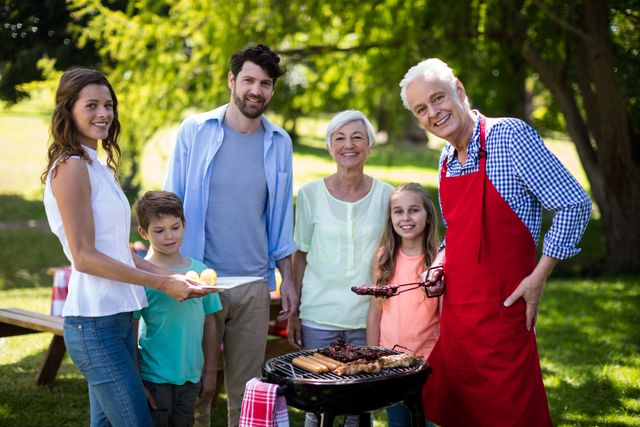 Multi-generation family enjoying a barbecue in a park. Perfect for illustrating family bonding, outdoor activities, summer picnics, and leisure time. Ideal for use in advertisements, family-oriented content, and lifestyle blogs.