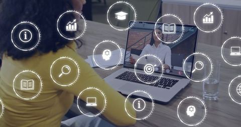 Remote team connecting via video call with augmented reality icons overlaying laptop screen