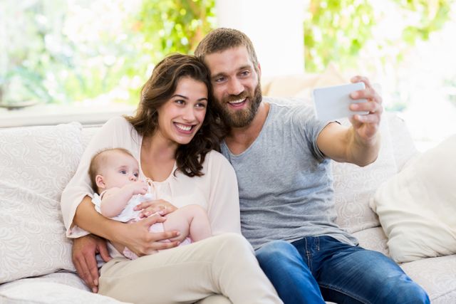 Family taking selfie on a mobile phone in living room