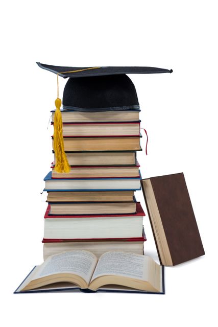 Graduation cap placed on top of a tall stack of books, symbolizing academic achievement and the pursuit of knowledge. Ideal for use in educational materials, school websites, graduation announcements, and academic success stories.
