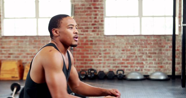 Focused Athlete Resting in Gym Environment - Download Free Stock Images Pikwizard.com