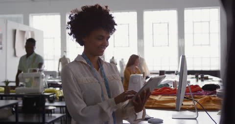 Fashion Student Smiling While Using Tablet in Creative Studio