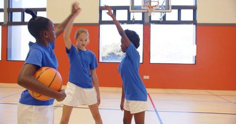 Diverse Young Girls Playing Basketball in Gymnasium