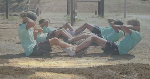 Children Performing Group Sit-Ups in Outdoor Camp Training