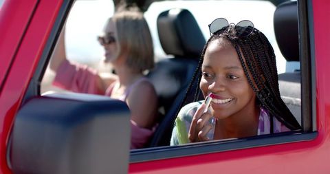 Young Women Enjoying a Sunlit Road Trip Experience - Download Free Stock Images Pikwizard.com