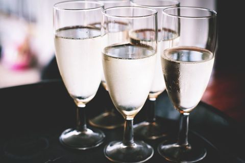 Chilled sparkling wine flutes clinking for celebration, wedding reception, party, elegant toast