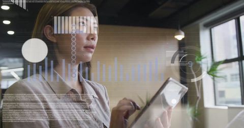 Business Professional Analyzing Data on Digital Tablet with Holographic Charts
