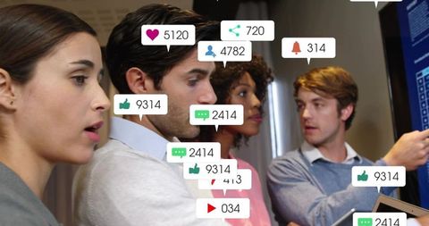 Team Analyzing Social Media Metrics on Touchscreen