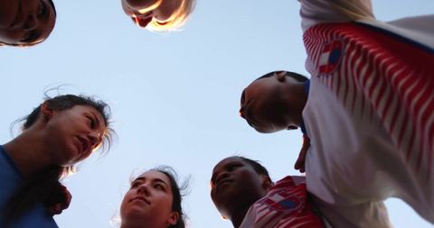 Unified soccer team huddling in motivation