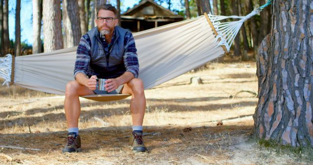 Outdoor enthusiast enjoying coffee while relaxing in nature - Download Free Stock Images Pikwizard.com