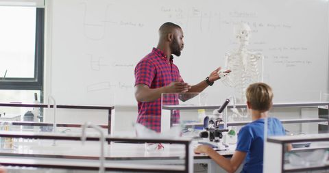 Diverse classroom engaged in anatomy lesson with african american teacher