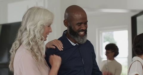 Guests mingling and smiling at joyful wedding reception