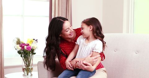 Mother and Daughter Embracing on Cozy Living Room Sofa - Download Free Stock Images Pikwizard.com