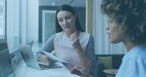 Professional Women Collaborating at Modern Office Desk