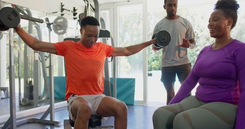 Young Adults Engaging in Motivational Workout Session at Modern Gym